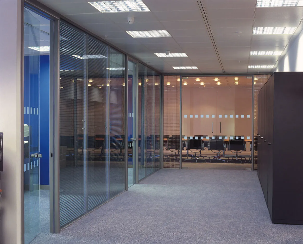 An empty conference room with glass walls and doors.