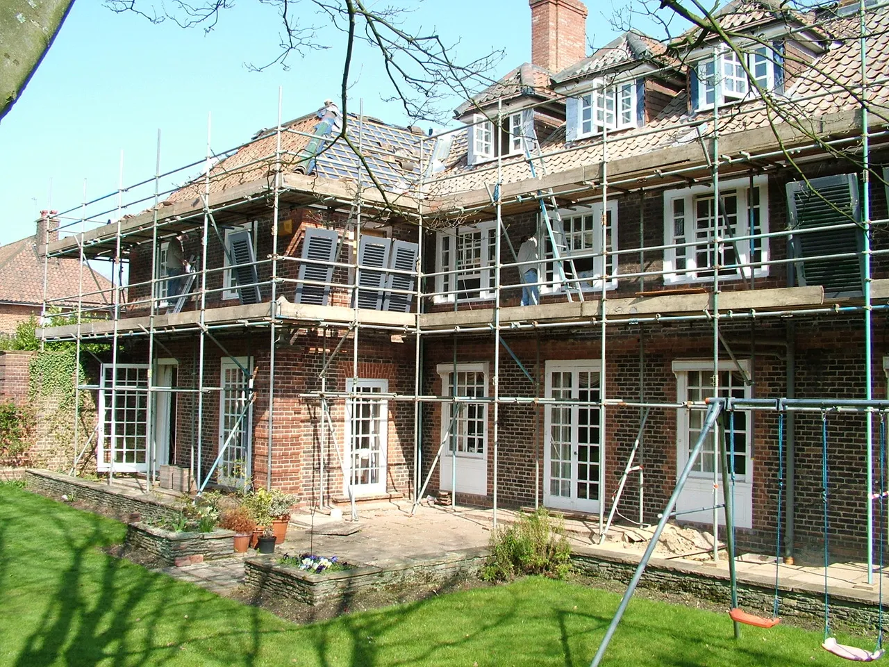 A large brick building with scaffolding around it.